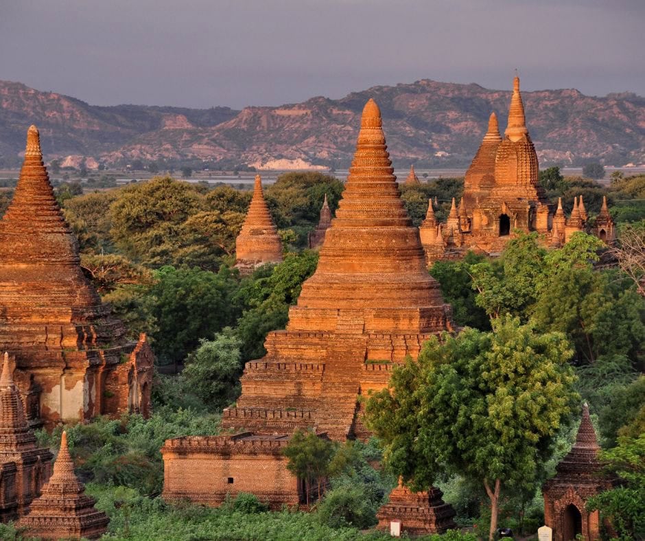 Ancient brick temples and pagodas rising above the trees in Bagan, Myanmar.