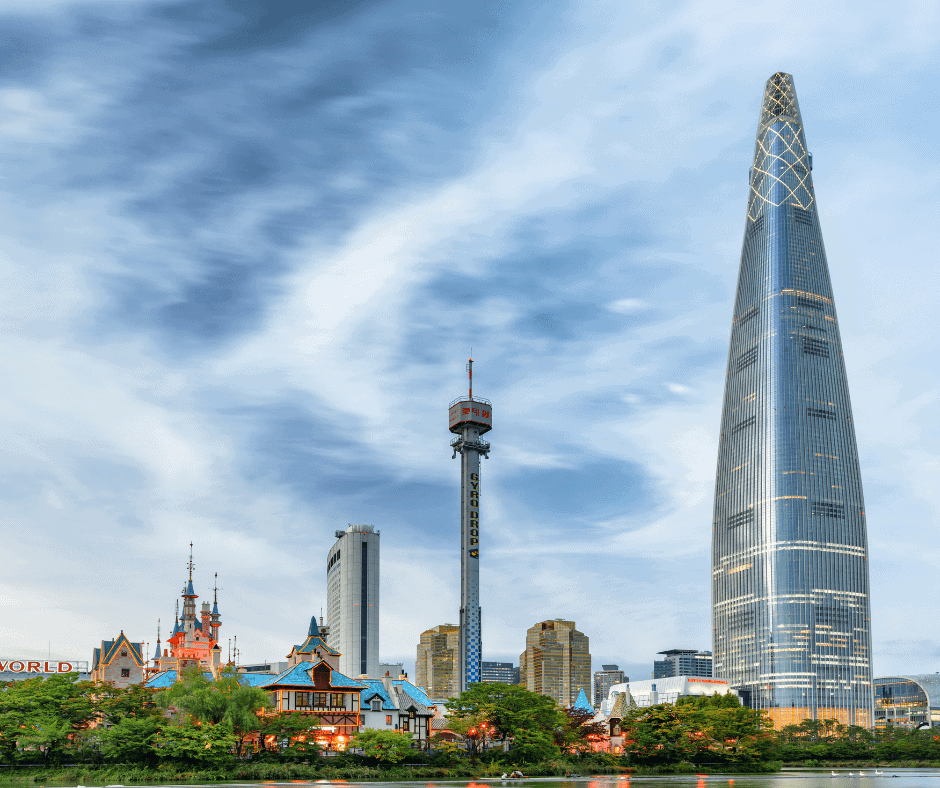 Lotte World Tower rising above the Seoul skyline under dramatic clouds, showcasing one of South Korea's most recognizable modern landmarks.