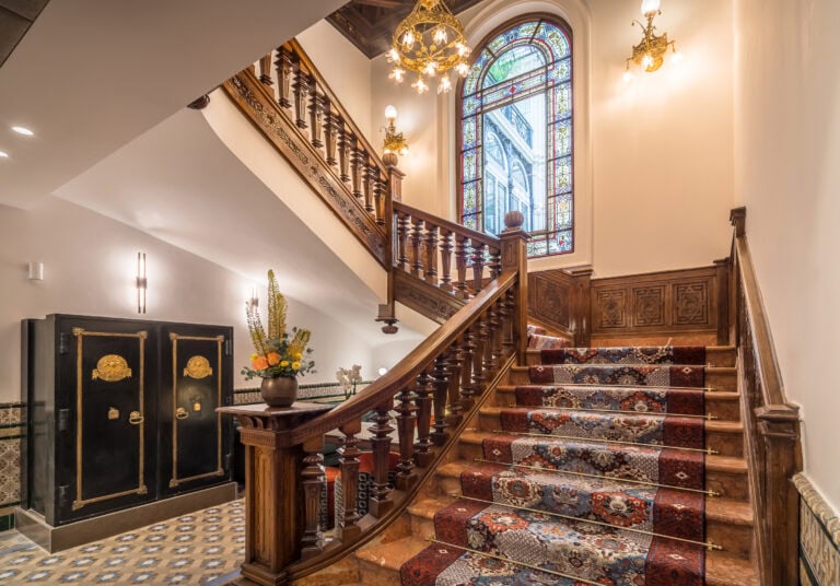 Historic marble staircase and high-ceilinged lobby at Palacio Gran Vía boutique hotel, Granada
