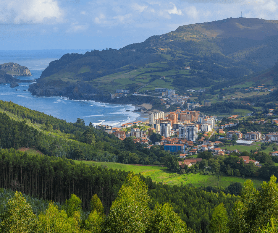 Green hills and coastal town along the rugged shoreline of northern Spain in the Basque Country