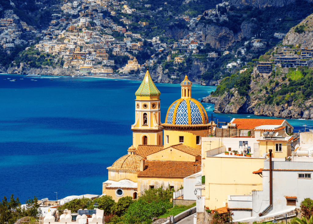 Church of Santa Maria Assunta in Positano with its colorful tiled dome overlooking the Amalfi Coast