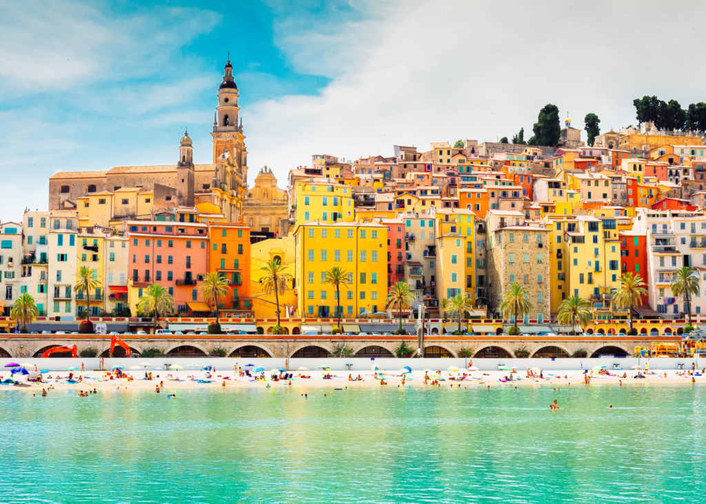Menton France old town with vibrant colorful buildings, beach and turquoise water on the French Riviera near the Italian border