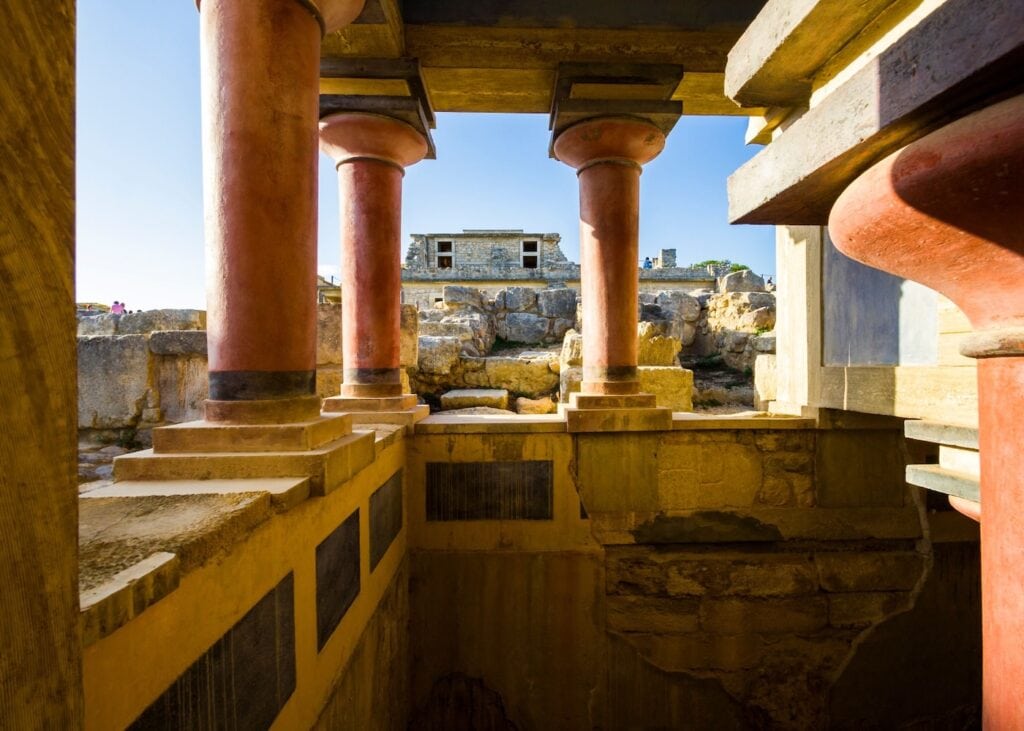 Restored red columns and ruins of the ancient Palace of Knossos near Heraklion, Crete, birthplace of the Minoan civilization
