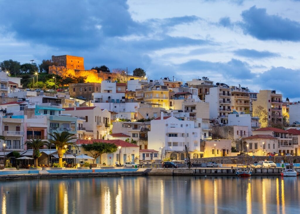Evening view of the Venetian Fortress overlooking the harbor and waterfront of Sitia, Crete, Greece.